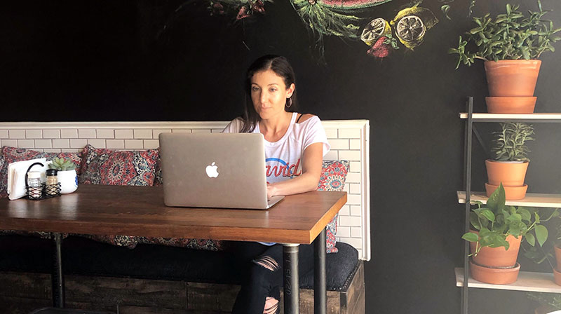 Recommended Courses from Lauren Grace Liviing: Lauren sitting at computer